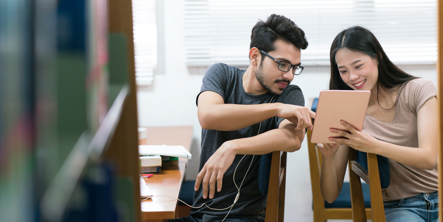 Photo: Two students using a tablet computer