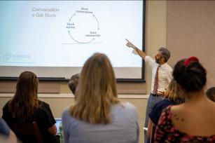 Photo: EP's John Sarrouf pointing toward projection (credit Buck Butler)