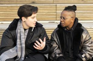 Image: Two transmasculine people in conversation